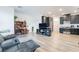 Open-concept living area connecting to a kitchen with dark cabinets and stainless steel appliances at 965 Nevada State Dr # 15104, Henderson, NV 89002