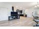 Inviting living room features an open layout with the kitchen, a TV, and modern light fixtures at 965 Nevada State Dr # 15104, Henderson, NV 89002
