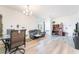 Open-concept living room with contemporary furniture, a sleek chandelier, and light wood flooring at 965 Nevada State Dr # 15104, Henderson, NV 89002