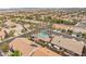 Aerial view showcases the community featuring lush landscaping and a sparkling blue pool at 9688 Meeks Bay Ave, Las Vegas, NV 89148
