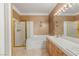 Bathroom featuring a double sink vanity, large mirror, decorative lighting, tile flooring and shower at 9688 Meeks Bay Ave, Las Vegas, NV 89148