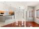 Open floor plan with modern lighting, kitchen area, and hardwood flooring at 9688 Meeks Bay Ave, Las Vegas, NV 89148
