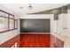 Bright living area with wood floors, statement wall, and large windows offering natural light at 9688 Meeks Bay Ave, Las Vegas, NV 89148