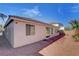 Back of home with desert landscaping, brick pavers, privacy wall and sliding glass doors at 981 Buffalo River Ave, Henderson, NV 89002