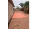 Gravel backyard featuring block wall fencing, a brick paver patio, and mature palm trees at 981 Buffalo River Ave, Henderson, NV 89002