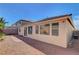 Back of home with desert landscaping, brick pavers, privacy wall and multiple windows at 981 Buffalo River Ave, Henderson, NV 89002