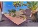 Landscaped backyard with desert rock, small plants and decorative palm trees at 981 Buffalo River Ave, Henderson, NV 89002