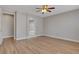 An airy bedroom with wood-look floors leading to bathroom at 981 Buffalo River Ave, Henderson, NV 89002