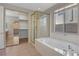 A luxurious bathroom features a soaking tub and glass-enclosed shower at 981 Buffalo River Ave, Henderson, NV 89002
