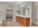 Bathroom featuring double sinks, a large mirror, and natural light at 981 Buffalo River Ave, Henderson, NV 89002