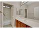 Bathroom with a long vanity, large mirror, and tub/shower combo at 981 Buffalo River Ave, Henderson, NV 89002