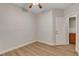 Bedroom featuring wood-look flooring, a window, ensuite and a ceiling fan at 981 Buffalo River Ave, Henderson, NV 89002