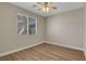 An inviting bedroom featuring neutral walls, wood-look flooring, and ceiling fan at 981 Buffalo River Ave, Henderson, NV 89002