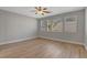 Bright bedroom featuring hardwood floors, a ceiling fan, and a sunlit window at 981 Buffalo River Ave, Henderson, NV 89002