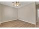Bright bedroom featuring modern ceiling fan, neutral walls, and sleek, light wood flooring at 981 Buffalo River Ave, Henderson, NV 89002