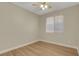 Sunlit bedroom featuring a ceiling fan, wood floors, and a window with blinds at 981 Buffalo River Ave, Henderson, NV 89002