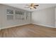 Bright bedroom with wood-look floors, three windows and a ceiling fan at 981 Buffalo River Ave, Henderson, NV 89002