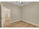 Bedroom featuring a door leading to an arched hallway and wood floors at 981 Buffalo River Ave, Henderson, NV 89002