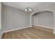 Dining room featuring wood floors, neutral walls, and an arched doorway at 981 Buffalo River Ave, Henderson, NV 89002