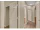 Hallway with gray walls, wood floors, a closet, and various doorways at 981 Buffalo River Ave, Henderson, NV 89002