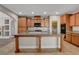 Open kitchen featuring granite countertops, wood cabinets, and a center island at 981 Buffalo River Ave, Henderson, NV 89002