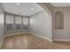 Living room featuring tile floors, neutral walls, and three large windows at 981 Buffalo River Ave, Henderson, NV 89002