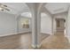 Bright, open-concept living room with light hardwood floors, neutral walls and a decorative archway at 981 Buffalo River Ave, Henderson, NV 89002
