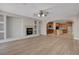 Open-concept living area with a fireplace, built-in shelving, and seamless flow into the kitchen and dining area at 981 Buffalo River Ave, Henderson, NV 89002