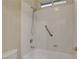 White shower/tub combination with a handheld shower head and grab bar at 981 Buffalo River Ave, Henderson, NV 89002