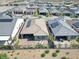 An aerial shot showcasing modern homes with solar panels, a paved patio, and desert landscaping at 10049 Cardinal Knoll Ave, Las Vegas, NV 89143