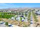Beautiful aerial view of community, showcasing the pool, landscaping, and surrounding houses with mountains in the background at 10049 Cardinal Knoll Ave, Las Vegas, NV 89143