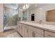 Modern bathroom features double sinks, granite counters, and tiled shower enclosure at 10049 Cardinal Knoll Ave, Las Vegas, NV 89143