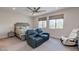 Spacious bedroom featuring a plush bed, a comfortable seating area, and bright windows at 10049 Cardinal Knoll Ave, Las Vegas, NV 89143