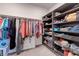 Walk-in closet with organized storage shelves, hanging rods, and ample space at 10049 Cardinal Knoll Ave, Las Vegas, NV 89143