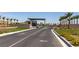 Community gate featuring palm tree lined walls and manicured landscaping for a luxurious entrance at 10049 Cardinal Knoll Ave, Las Vegas, NV 89143
