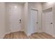Clean, well-lit foyer with wood-look tile flooring, white doors, and modern hardware at 10049 Cardinal Knoll Ave, Las Vegas, NV 89143