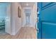Modern entryway with wood-look tile flooring and a bright blue front door at 10049 Cardinal Knoll Ave, Las Vegas, NV 89143