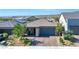 Well-maintained front yard featuring a paved driveway, desert landscaping, and a charming covered front porch at 10049 Cardinal Knoll Ave, Las Vegas, NV 89143