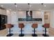 Gourmet kitchen island with granite countertops, pendant lighting, and seating for four at 10049 Cardinal Knoll Ave, Las Vegas, NV 89143