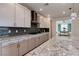 Kitchen island showcasing granite countertops, pendant lights, and seamless flow to dining area at 10049 Cardinal Knoll Ave, Las Vegas, NV 89143