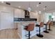 Bright kitchen with a large island, stainless steel appliances, and modern lighting fixtures at 10049 Cardinal Knoll Ave, Las Vegas, NV 89143