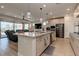 Open-concept kitchen island with stainless steel appliances and seamless connection to living area at 10049 Cardinal Knoll Ave, Las Vegas, NV 89143