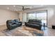 Spacious living room with two couches, a decorative rug, and a large sliding glass door to the outdoor patio at 10049 Cardinal Knoll Ave, Las Vegas, NV 89143