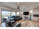 Cozy living room with comfortable seating, a large sliding door to the backyard, and a modern ceiling fan at 10049 Cardinal Knoll Ave, Las Vegas, NV 89143