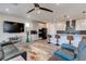 Open-concept living room and kitchen with stainless steel appliances and a comfortable seating area at 10049 Cardinal Knoll Ave, Las Vegas, NV 89143