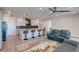 Open floor plan featuring a modern kitchen with bar seating and a living room with comfortable seating at 10049 Cardinal Knoll Ave, Las Vegas, NV 89143