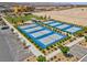 Overhead view of the community's eight new blue and gray pickleball courts, surrounded by landscaping and parking at 10049 Cardinal Knoll Ave, Las Vegas, NV 89143