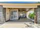 Inviting covered back patio featuring stone accents and outdoor seating area at 10237 Andante Ct, Las Vegas, NV 89135