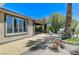 View of covered patio featuring stone columns, window, and landscaping at 10237 Andante Ct, Las Vegas, NV 89135