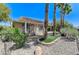 Backyard with covered patio, pergola, desert landscaping, and rock features at 10237 Andante Ct, Las Vegas, NV 89135